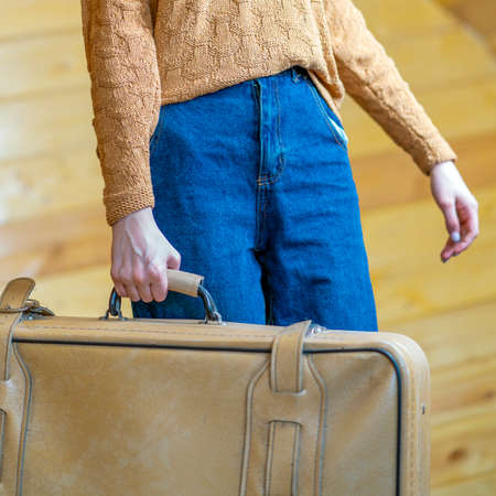Closeup hands of travel woman holding big suitcase ready for business trip vacation.