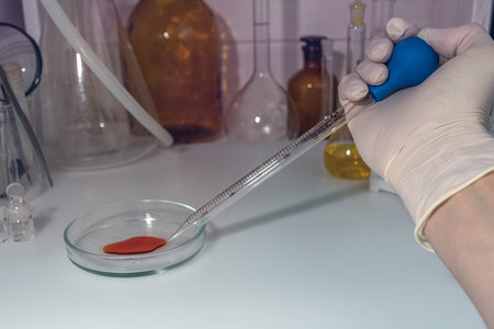 a laboratory assistant working with blood sample in laboratoryの写真素材