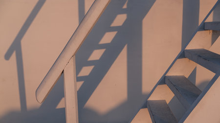 Staircase with shadow. Sunset. Cosmetic background. Empty stand with geometric shape on pastel backgroundの写真素材
