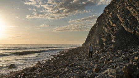 Rock stone stage in nature with sea beach seashore landscape and sunset sky nature background.
