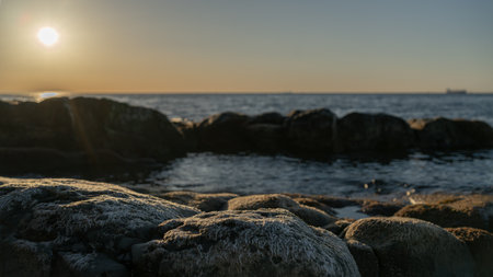 Rock stone stage in nature with sea beach seashore landscape and sunset sky nature backgroundの写真素材