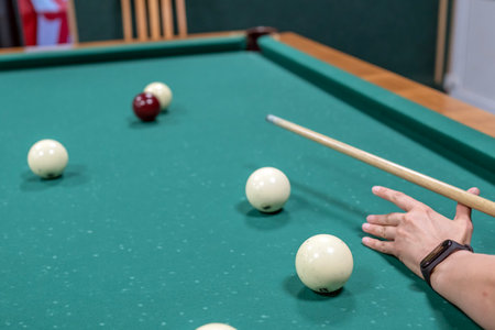 A young man plays Russian billiards, an man in a billiards club and bar. A man pockets snooker balls.の写真素材