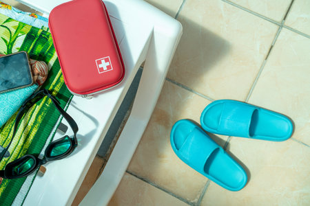 Red bag with first aid kit on sun lounger in indoor swimming poolの写真素材