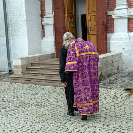 A monastery minister enters a church.