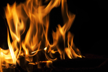 Fire flames on a black background. Blaze fire flame texture background. Close up of fire flames...