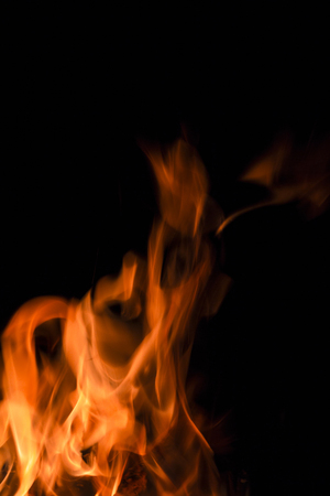 Fire in vector format for use as a design element or a creative background. Fire flame on black background.の写真素材