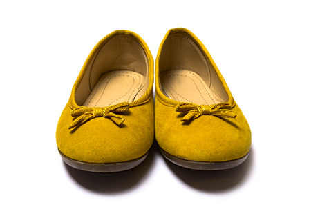 yellow female shoes closeup view from above on white backgroundの写真素材