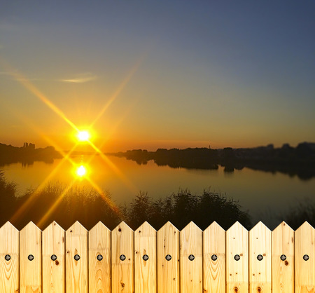 Nice scene with sunset over lake waterの写真素材