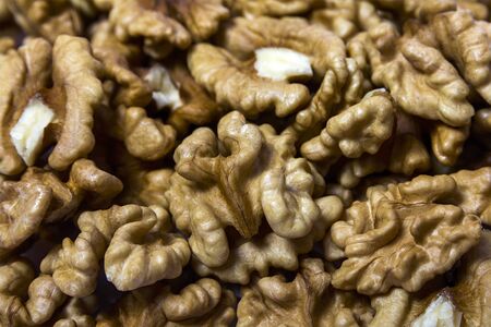 Closeup of Peeled Walnuts Pile. Walnuts Background. Many Different Textured Walnuts.の写真素材
