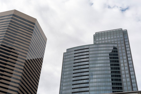 Bottom view of modern skyscrapers in business district against blue sky.の写真素材