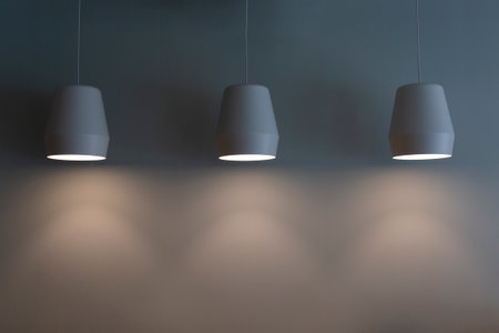 Blank cement wall with three lamps aboveの写真素材