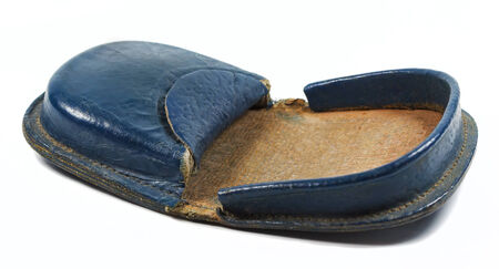 Old open an empty leather purse on a white background
