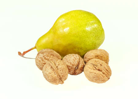 Ripe pear and walnuts isolated on a white backgroundの写真素材