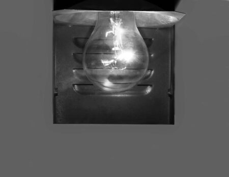 Burning electric lamp on a grey backgroundの写真素材