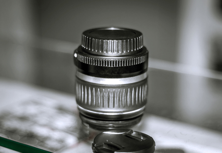 The camera lens on the glass blurred backgroundの写真素材