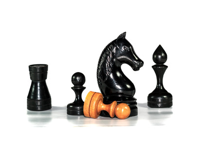 Several chess figures blurred with pawn on white background with reflectionの写真素材