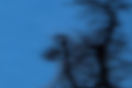 Abstract background with blue hue and smeared with black spotsの写真素材