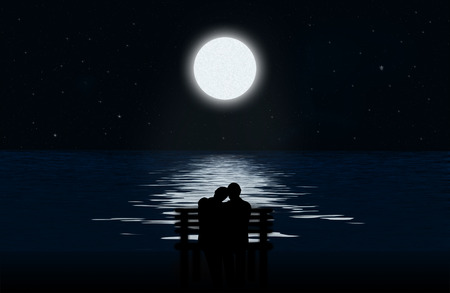 Silhouette of a loving couple on a bench on the background of the moon and lunar path on water surfaceの写真素材