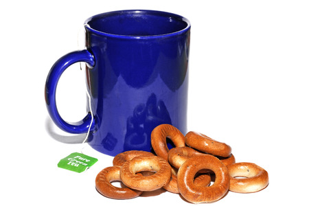 Blue cup of tea and bagels isolated on white backgroundの写真素材