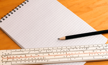 Pencil ruler and notebook on a wooden backgroundの写真素材