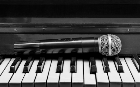 Black and white pianos and wireless microphoneの写真素材