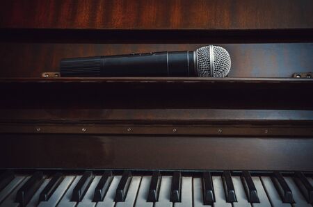 Stylized piano and wireless microphone close upの写真素材