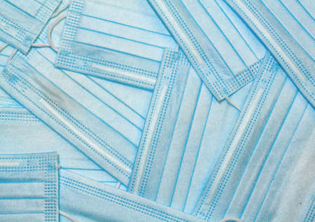 Background of laid out blue protective medical masksの写真素材