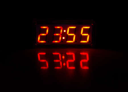 Digital clock in the dark with reflectionの写真素材