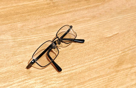 Glasses for vision on a wooden surface