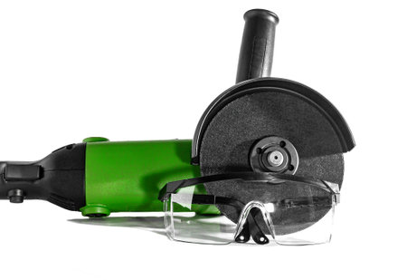 Safety glasses and an angle grinder isolated on white background