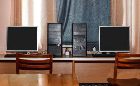 Two computers in a computer room with classic desktop computers