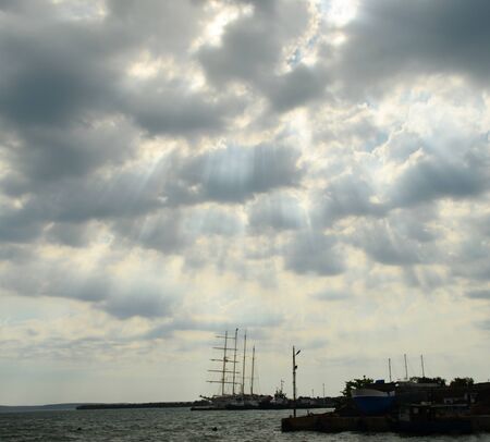 Ship in Caribbean sea, Harbour in Cienfuegos, Cuba. Cloudy Sundown.