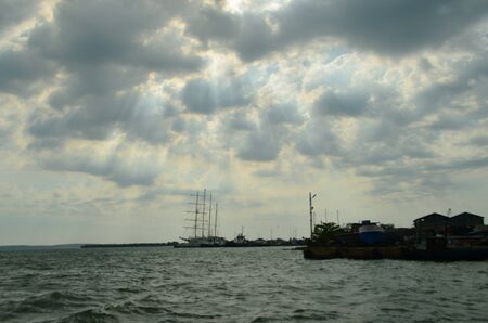 Ship in Caribbean sea, Harbour in Cienfuegos, Cuba. Cloudy Sundown.