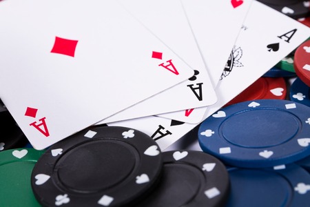 Poker chips and cards on white background