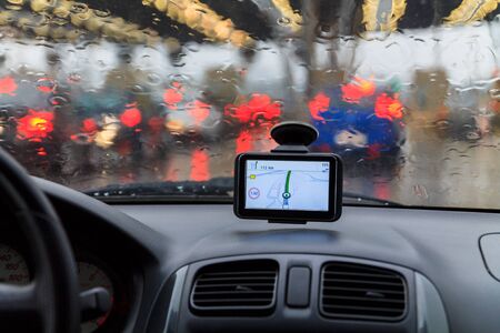Raindrops on a car window, on blurred traffic image
