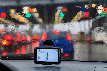 Raindrops on a car window, on blurred traffic image
