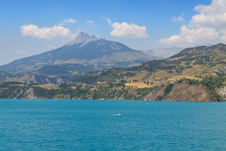 Panoramic view of the beautiful blue lago di Serre-Poncon in the alps in Franceの写真素材