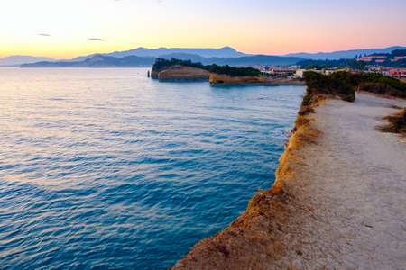 Famous Canal d'Amour beach with beautiful rocky coastline in amazing blue Ionian Sea at sunrise in Sidari holiday village on Corfu island in Greeceの写真素材