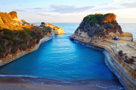 Famous Canal d'Amour beach with beautiful rocky coastline in amazing blue Ionian Sea at sunrise in Sidari holiday village on Corfu island in Greeceの写真素材