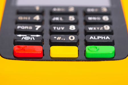 Yellow credit card reader terminal on isolated background. Easy payment method.の写真素材