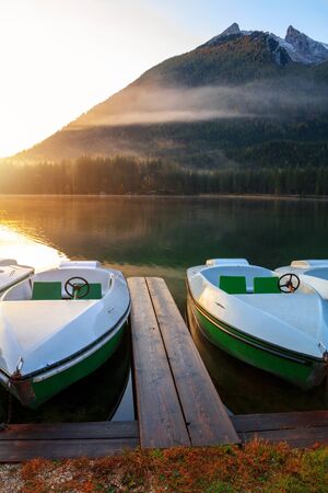 Beautiful autumn colors in the sunrise at the Hintersee lake in Bavaria alps in Germanyの写真素材