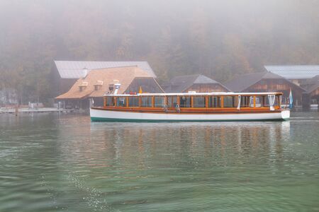 Konigssee lake (Konigsee) in foggy weather, St. Bartholoma church the background Watzmann mountains , near the German Austrian border, Berchtesgaden National Park, Bavaria in Germanyの写真素材