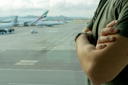 traveler man looks his watch waiting for his plane to depart