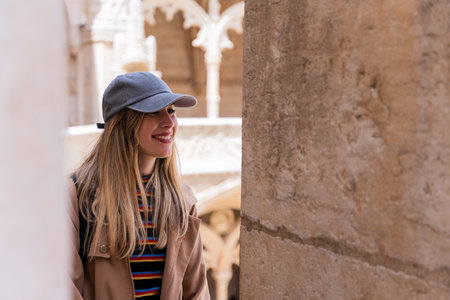 Close-up of a smiling tourist woman looking at emblematic architecture of Europe.の写真素材