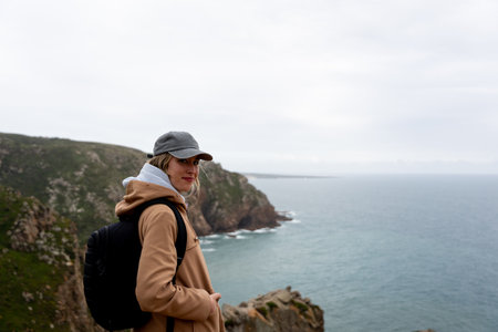 Happy and smiling woman contemplating the panoramic views of the cliffs.の写真素材