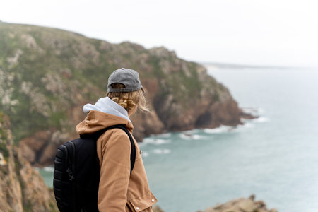 Traveler woman contemplating the panoramic views from the cliffs.の写真素材