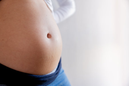 Close-up of a pregnant womans belly with space to copy text in the backgroundの写真素材