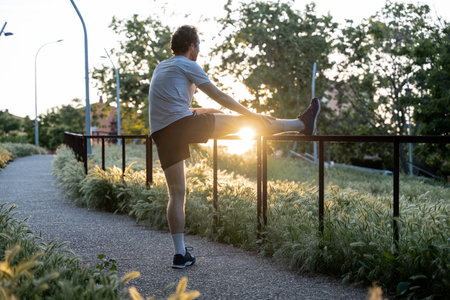 Adult man doing physical exercise and stretching outdoorsの写真素材