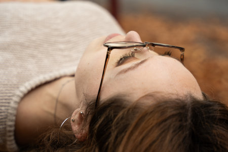 Woman relaxing and experiencing peaceful tranquility in autumn seasonの写真素材