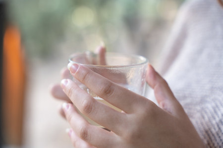 Woman sitting contemplating, enjoying a warm cup of herbal teaの写真素材